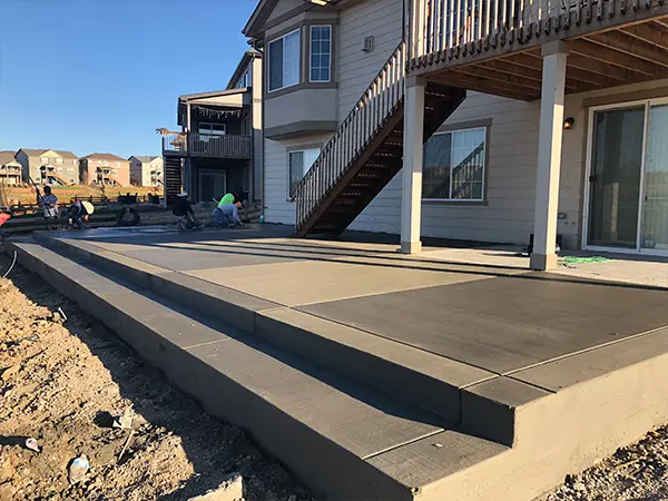 Freshly installed concrete patio by Easy Green Landscaping, ideal for outdoor living spaces.