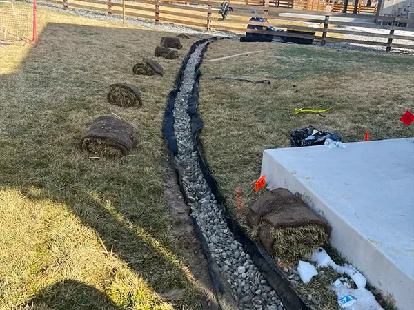 French drain installation process for backyard drainage by Easy Green Landscaping.