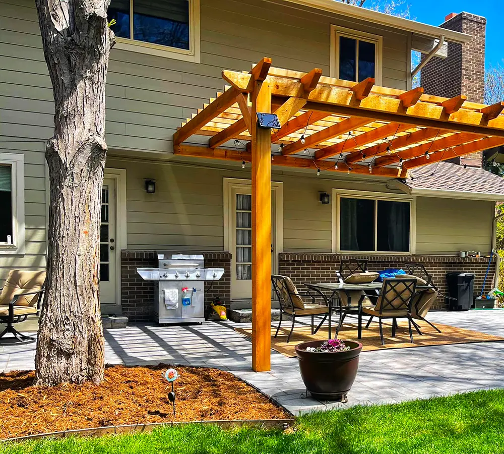 Custom patio with pergola for backyard shade and outdoor enjoyment by Easy Green Landscaping.