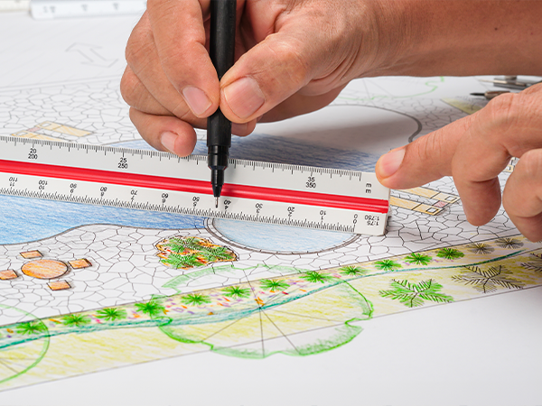 Close-up of landscape design blueprint with ruler and pen