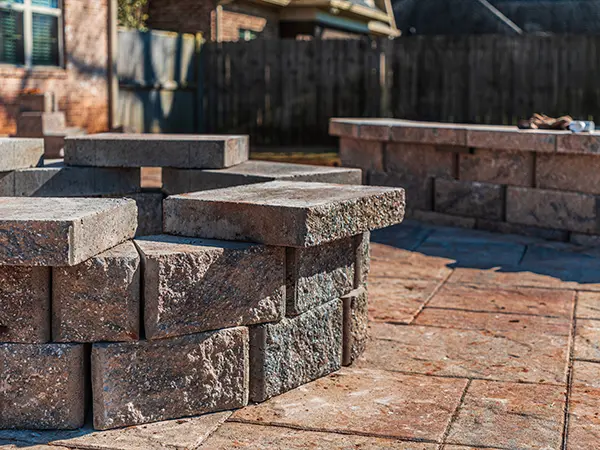 Close-up of a professionally constructed stone firepit on a stylish patio for outdoor gatherings.